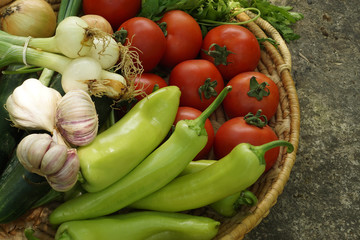 Vegetables in a basket on a stone base