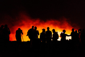 Silhouette of people by glowing light