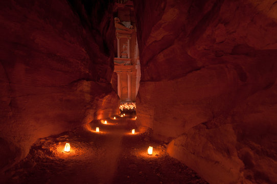 Narrow passageway to petra illuminated by candlelight
