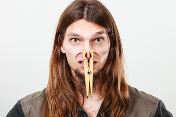 Man with clogged nose by clothespin