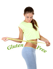 Fototapeta na wymiar Young slim woman measuring her waist and text Gluten free isolated on white