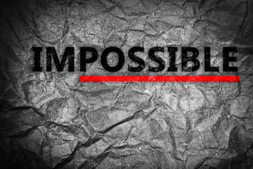 Word impossible transformed into possible on grey wall