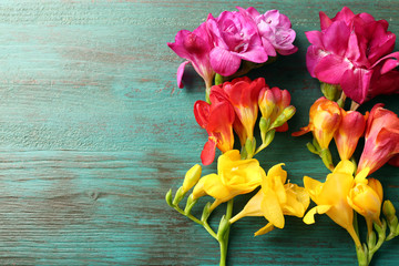 Beautiful freesia flowers on wooden background