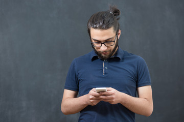 picture of young arab man on chalkboard using phone