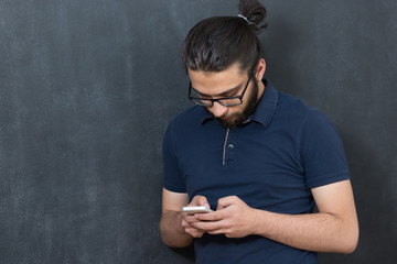 picture of young arab man on chalkboard using phone