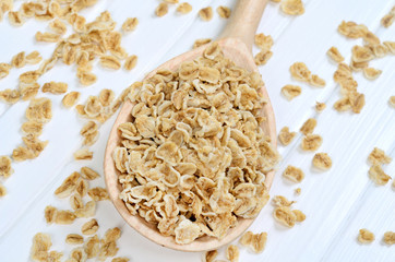 Oat flakes in wooden spoon