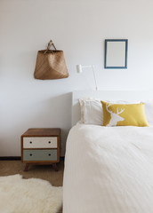 Bedroom details of retro decor side table and wall ornaments