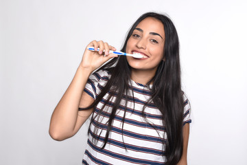 Woman brushing her teeth.