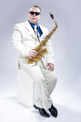 Naklejka premium Music Concept and Ideas. Full Length Portrait of Caucasian Musician With Alto Saxophone