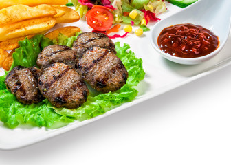 French fries, meatballs on the lettuce, vegetables and barbecue