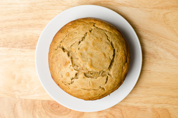 Homemade banana cake on white plate and wooden background