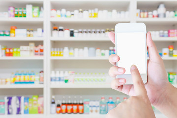 female pharmacist hold mobile smartphone in the pharmacy