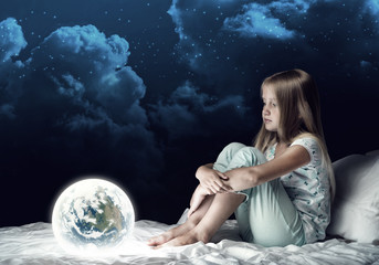 Naklejka premium Girl in her bed and glowing globe