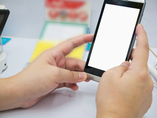 female hand hold mobile smartphone in mobile phone shop