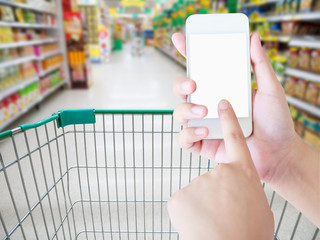 Female hand holding mobile smart phone on Supermarket