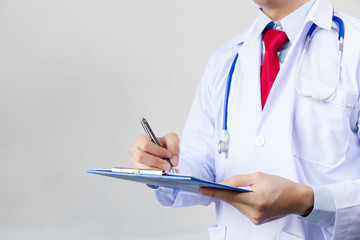 Medical doctor writing prescription on white isolated background (Focus on clipboard)