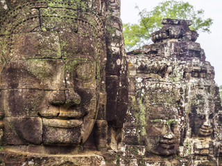 Stone faces at the ancient Bayon temple at Angkor, Siem Reap, Cambodia.
