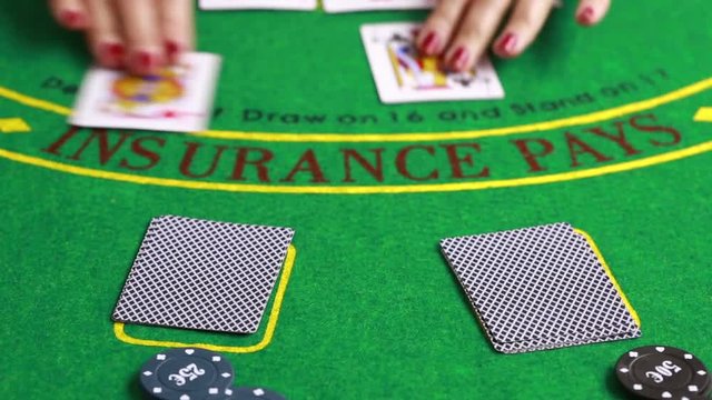 dealer handling playing cards at a poker table