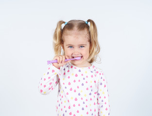 Little girl brushing her teeth.