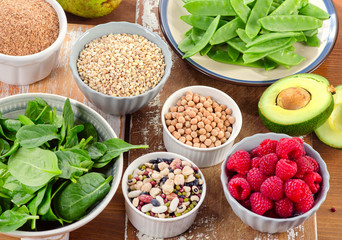 Fiber and carbs rich foods on a wooden board.