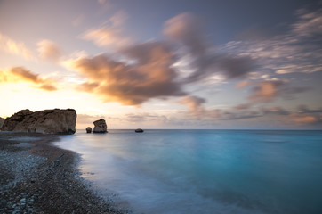 Fototapeta premium The Rock of the Greek, Cyprus. Place of the birth of the goddess Aphrodite. Petra tou Romiou. Movement of clouds on long exposure