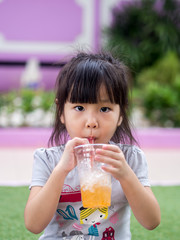 Beautiful asian girl drinking with a straw
