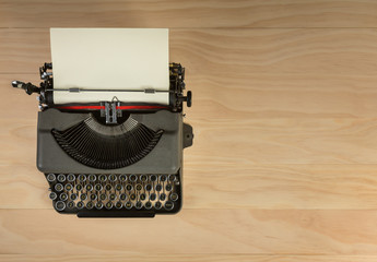 vintage typewriter isolated on wooden background