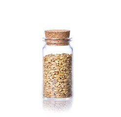 organic oat rice in transparent glass bottle  