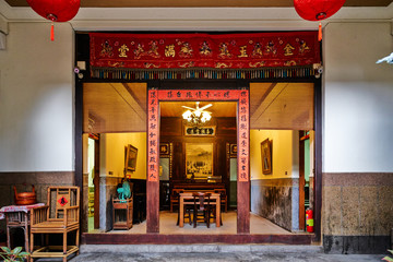 Fototapeta na wymiar Traditional oriental chinese heritage building with spring couplets&red lantern in Taiwan (Chinese Translation on board : home full of wealth and blessing)