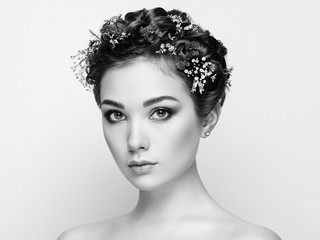 Face of beautiful woman decorated with flowers. Perfect makeup. Beauty fashion. Eyelashes. Cosmetic Eyeshadow. Black and white