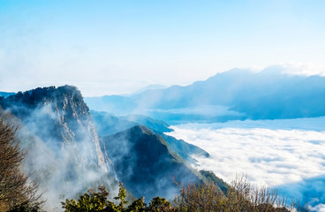 Beautiful morning sunrise, dramatic cloud of sea, giant rocks and Yushan mounatin under bright blue sky in Alishan(Ali mountain) National Park, Taiwan