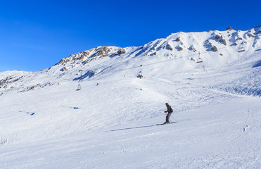 Fototapeta na wymiar Skiers on the slopes of the ski resort of Meribel, France