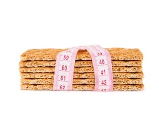 Diet Crispbread and measuring tape isolated
