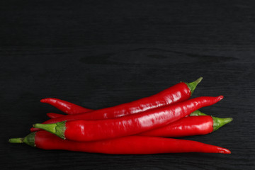 hot red chili pepper on black wooden background