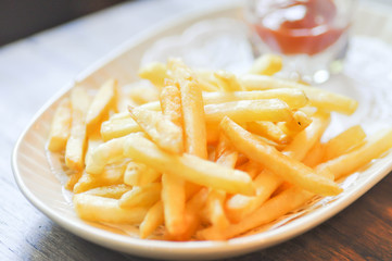 French fries dish and ketchup dip in soft focus