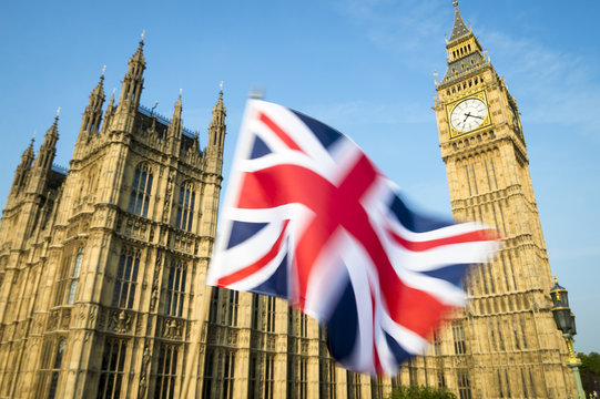 Great British Union Jack flag flying in motion blur in front of Big Ben and the Houses of Parliament at Westminster Palace, London, in preparation for the Brexit EU referendum