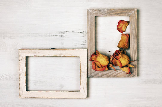 Wooden photo frames with dry roses