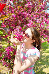 Beauty of nature. Young teenage girl smelling cherry tree flower
