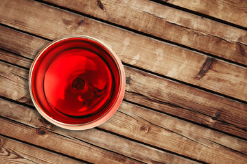 top of view of red wine in the glass isolated on wood background