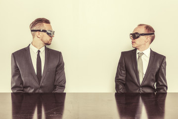 Two businessman sitting at office desk