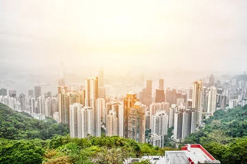 Fotobehang Business concept for real estate and corporate construction - panoramic modern city skyline bird eye aerial view with dramatic sunrise and morning blue sky in Hong Kong (HK), China © voyata