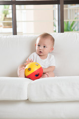 asian baby playing with ball