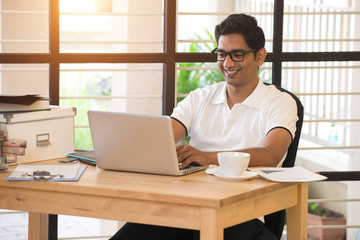 casual indian male working at office