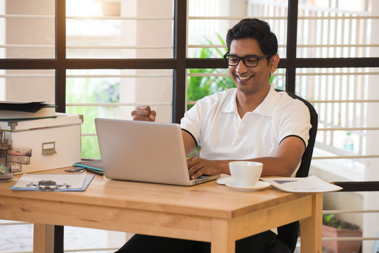 Young Indian Man Celebrating Success While Working