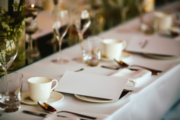 Served table with invitation, bokeh