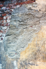 .Grunge texture of old wall. Cracked stucco crumbles.