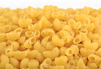 Heap of uncooked italian pasta pipe rigate on a white