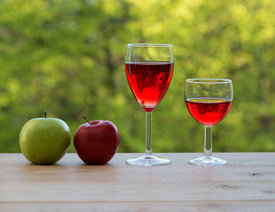 wine glasses and colorful apples on table