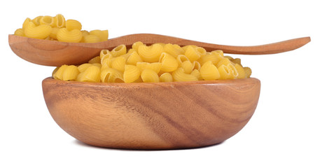 Uncooked italian pasta pipe rigate in a wooden bowl on a white
