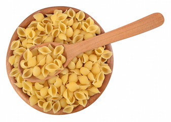 Uncooked italian pasta shells in a wooden bowl on a white